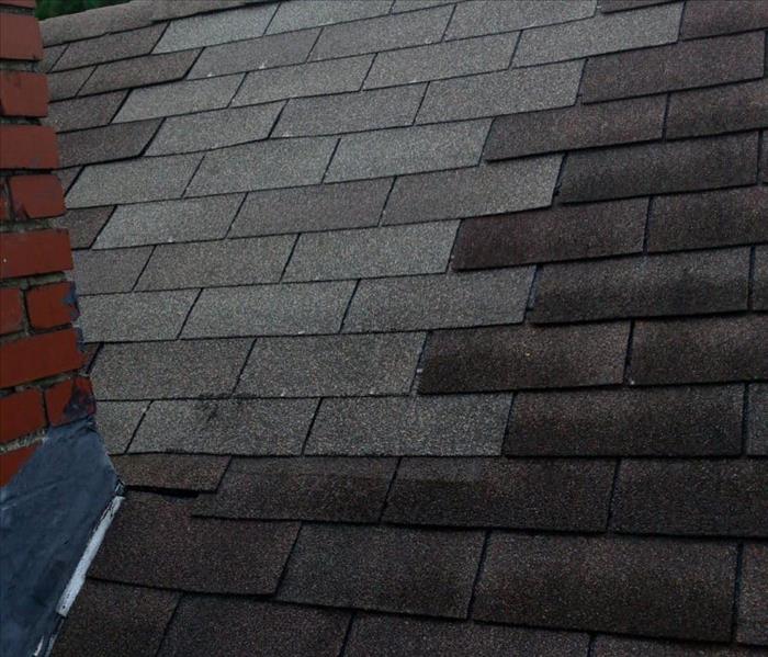 image of shingle repair after this home experienced hail and strong winds damaging the roof
