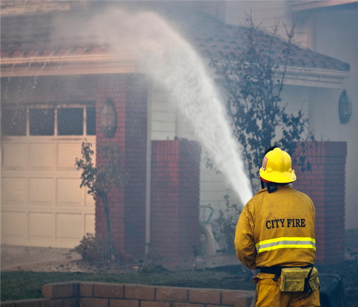 fireman putting out housefire